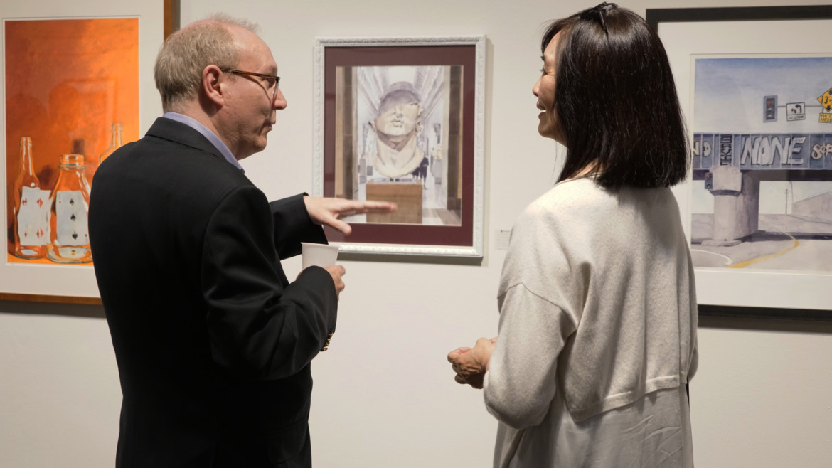 School of Fine Art alumna and exhibition curator Ellie Marcial poses next to her work titled, Post and Kearney, watercolor on aquaboard. Photo by Bob Toy.