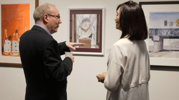School of Fine Art alumna and exhibition curator Ellie Marcial poses next to her work titled, Post and Kearney, watercolor on aquaboard. Photo by Bob Toy.