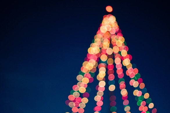 An outdoor and artfully blurred Christmas tree of multi-color lights. Photo by Tim Mossholder from Pexels.