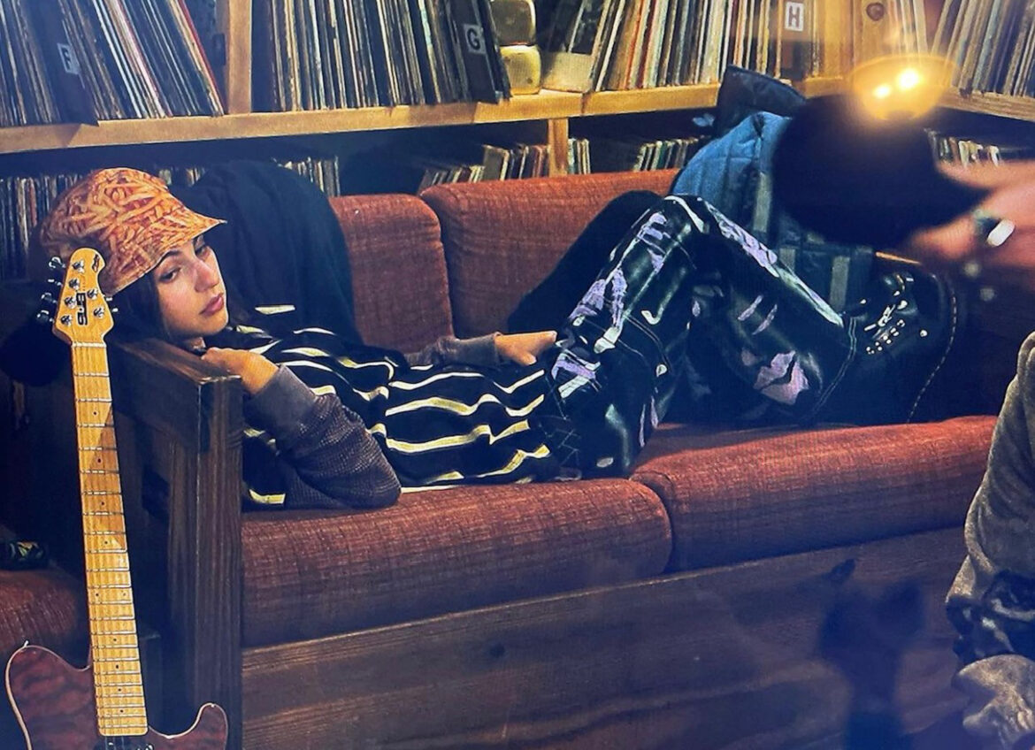 Actress Madeline Weinstein wears black cargo pants featuring spray painted designs by Makayla Godden on HBO series, “Mare of Easttown.”